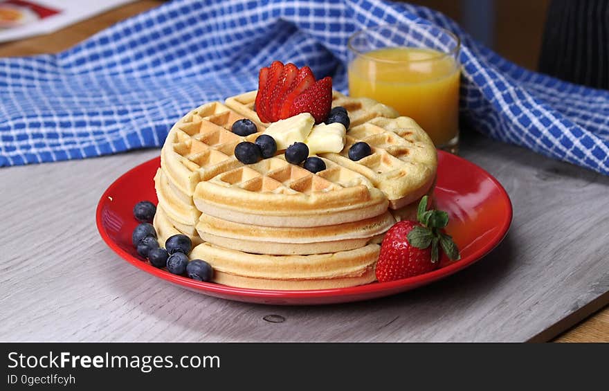 Breakfast waffles with fresh berries and juice.