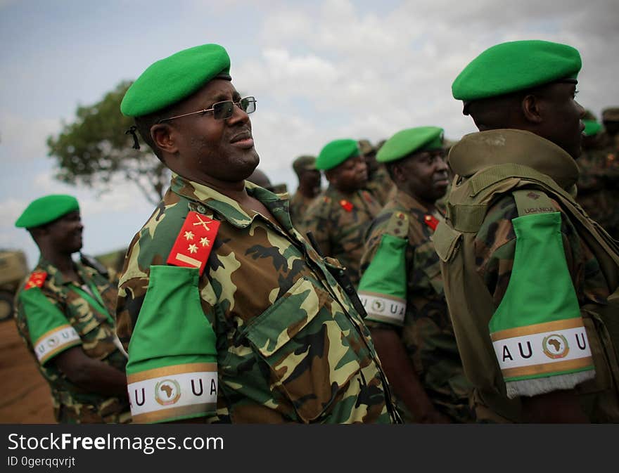 African Union Mission in Somalia &#x28;AMISOM&#x29; officers from Burundi and Uganda listen while AMISOM Force Commander Lt. Gen. Andrew Gutti &#x28;not seen&#x29; addresses Ugandan soldiers serving with the AU operation 5 June in Afgoye located 30km to the west of the Somali capital Mogadishu. AMISOM supporting Somali National Army &#x28;SNA&#x29; forces recently liberated the Afgoye Corridor from the Al Qaeda-affiliated extremist group Al Shabaab, pushing them further away from Mogadishu and opening up the free flow of goods and produce between the fertile agricultural area surrounding Afgoye and the Somali capital. AU-UN IST PHOTO / STUART PRICE. African Union Mission in Somalia &#x28;AMISOM&#x29; officers from Burundi and Uganda listen while AMISOM Force Commander Lt. Gen. Andrew Gutti &#x28;not seen&#x29; addresses Ugandan soldiers serving with the AU operation 5 June in Afgoye located 30km to the west of the Somali capital Mogadishu. AMISOM supporting Somali National Army &#x28;SNA&#x29; forces recently liberated the Afgoye Corridor from the Al Qaeda-affiliated extremist group Al Shabaab, pushing them further away from Mogadishu and opening up the free flow of goods and produce between the fertile agricultural area surrounding Afgoye and the Somali capital. AU-UN IST PHOTO / STUART PRICE.