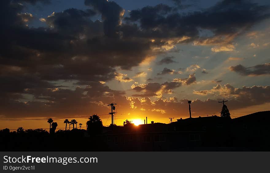 A landscape is silhouetted by a sunset. A landscape is silhouetted by a sunset.