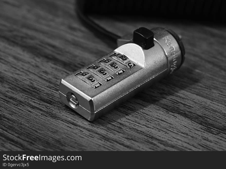 Closeup of a silver combination lock.