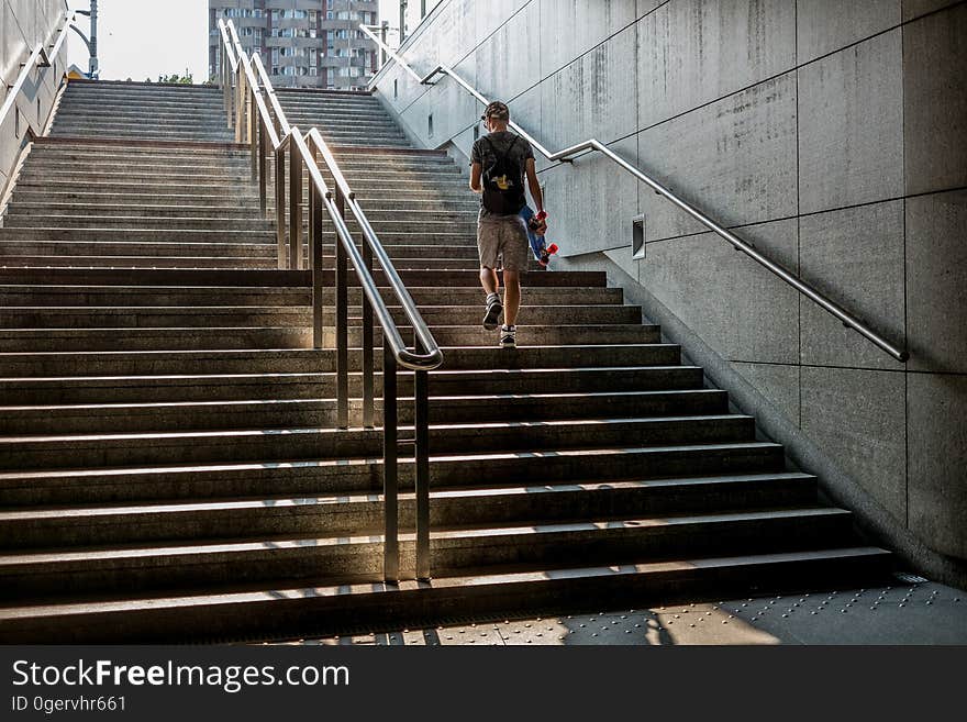 A man walking up an outdoor staircase. A man walking up an outdoor staircase.