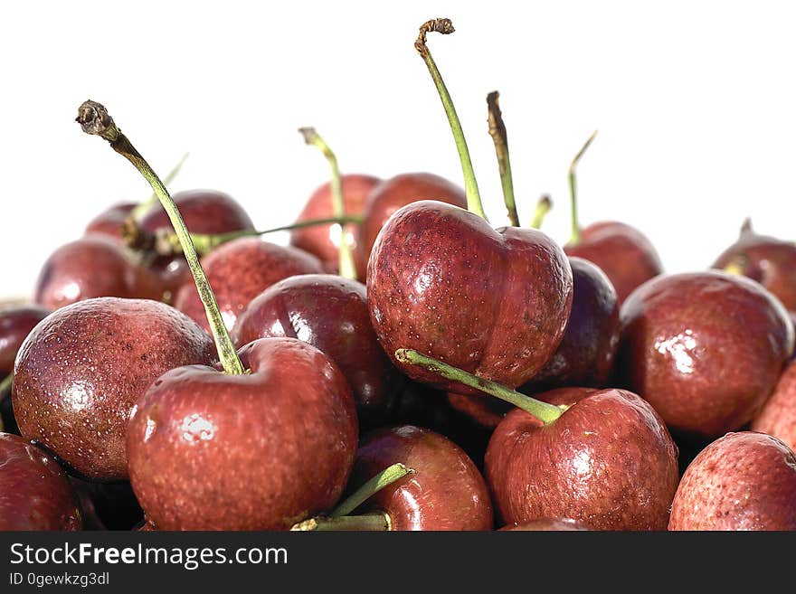 Red fresh cherries on white background close-up.