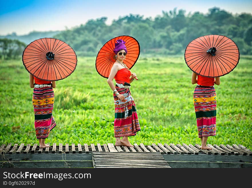 Thai Woman In Traditional Costume with umbrella thai culture style on oudoor. Thailand.