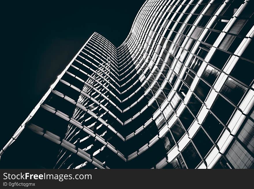 A high rise building with a curved facade in black and white.