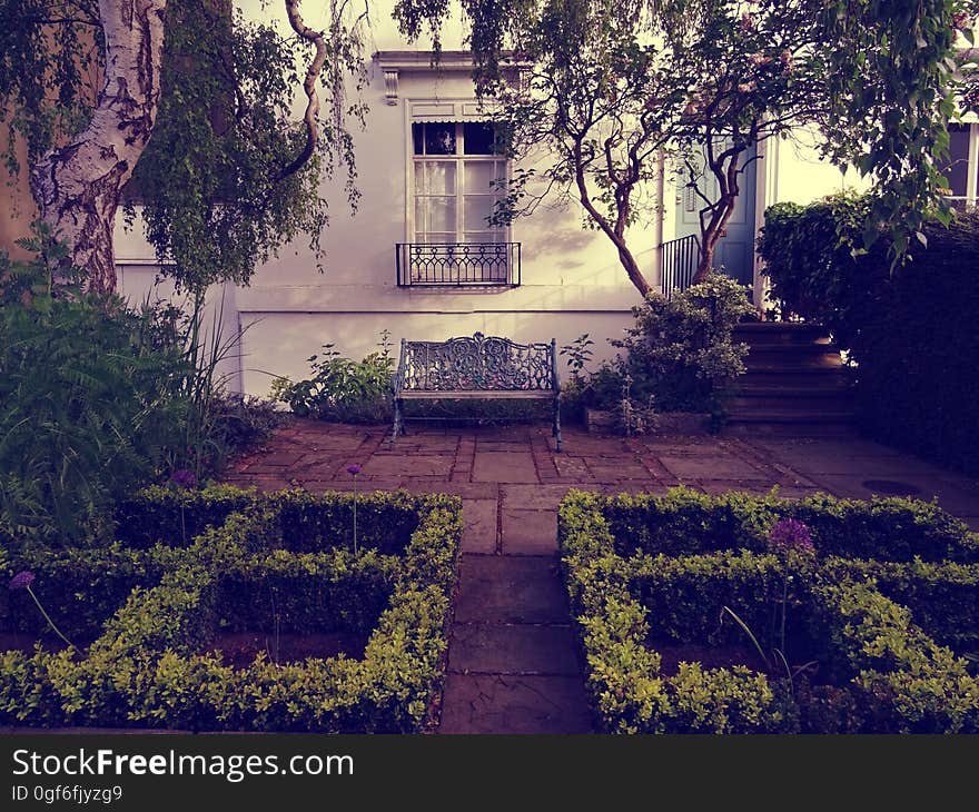 Exterior of old house with landscaped garden and patio in foreground. Exterior of old house with landscaped garden and patio in foreground.