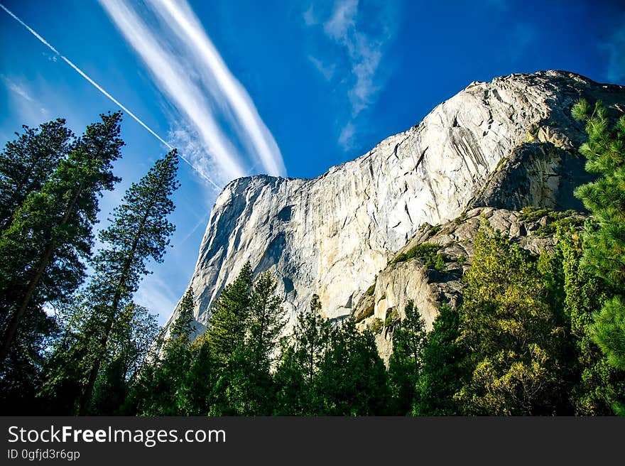 A majestic mountain peak surrounded by a forest. A majestic mountain peak surrounded by a forest.