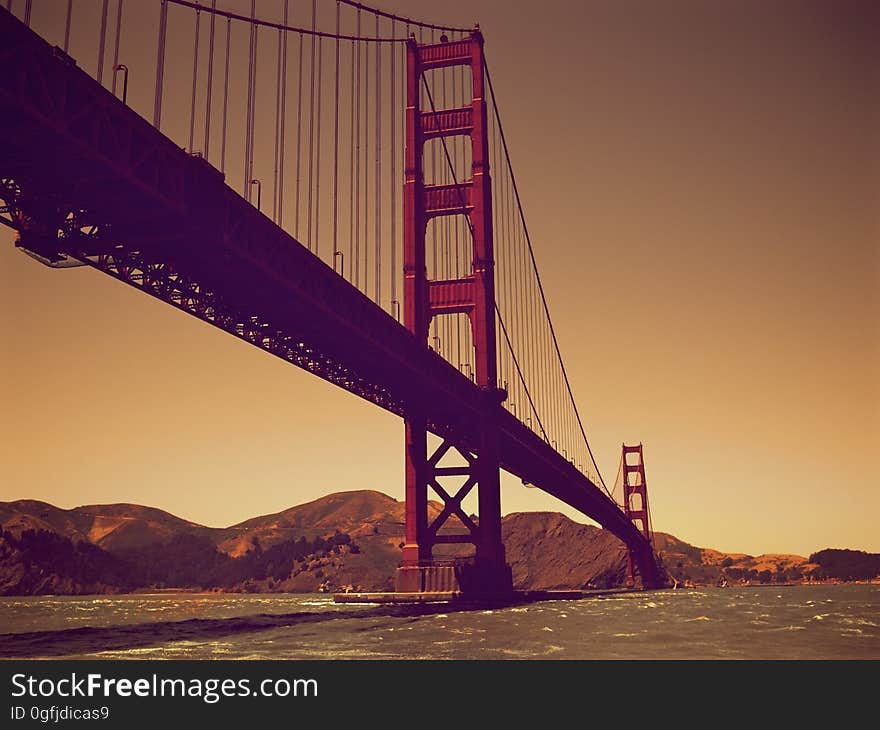 Scenic underside view of Golden Gate bridge at sunset. California, USA.