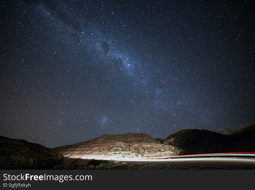 A beautiful starry night sky overlooking a mountain range.