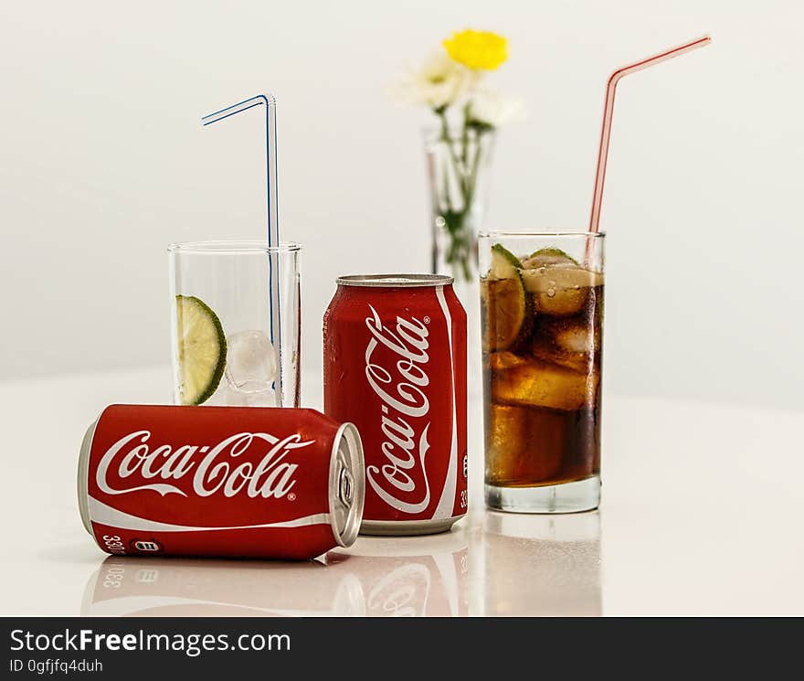 Coca Cola Cans and Glasses With Lines