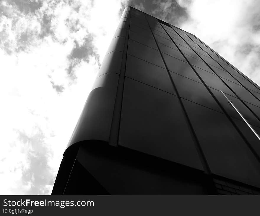 Upward view from the base of a modern black high rise. Upward view from the base of a modern black high rise.