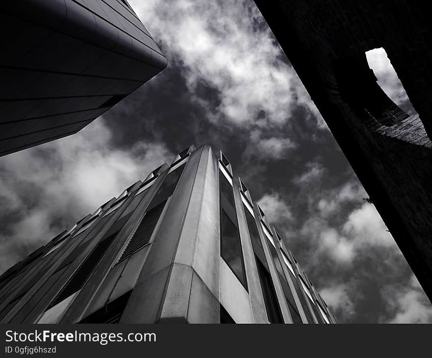 A black and white photo of downtown buildings seen from the street.