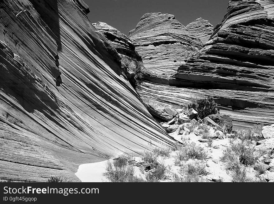 Grey Scale Photography of Rocky Mountain Grass Fields