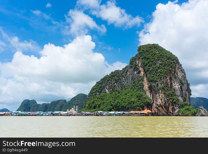 Scenic View of an Island Against Cloudy Sky