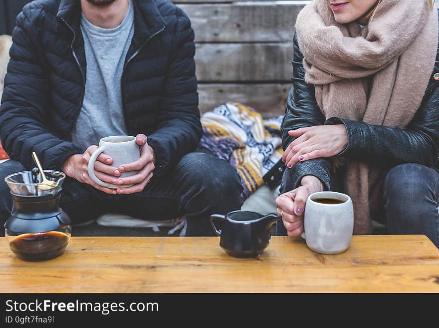 A man and a woman having a coffee outdoors. A man and a woman having a coffee outdoors.