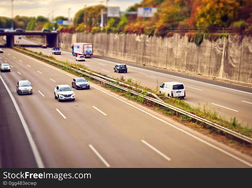 A six-lane freeway with cars on it. A six-lane freeway with cars on it.