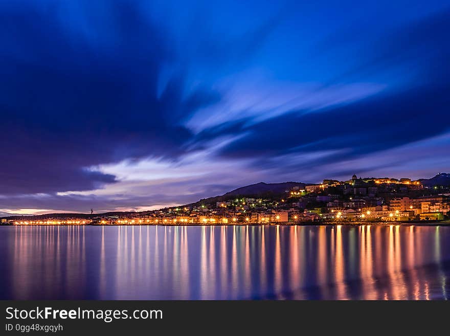 The city lights reflecting from the surface of the water at night. The city lights reflecting from the surface of the water at night.