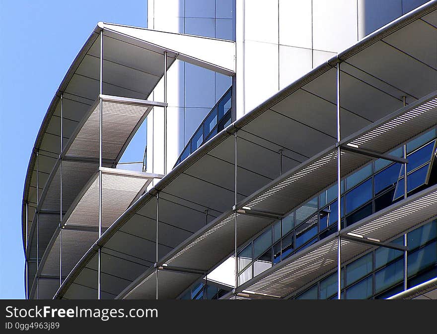 A modern building with curved scaffolding around the exterior.