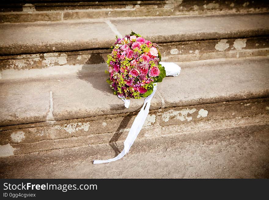 Flower Bouquet on Stairs during Daytime