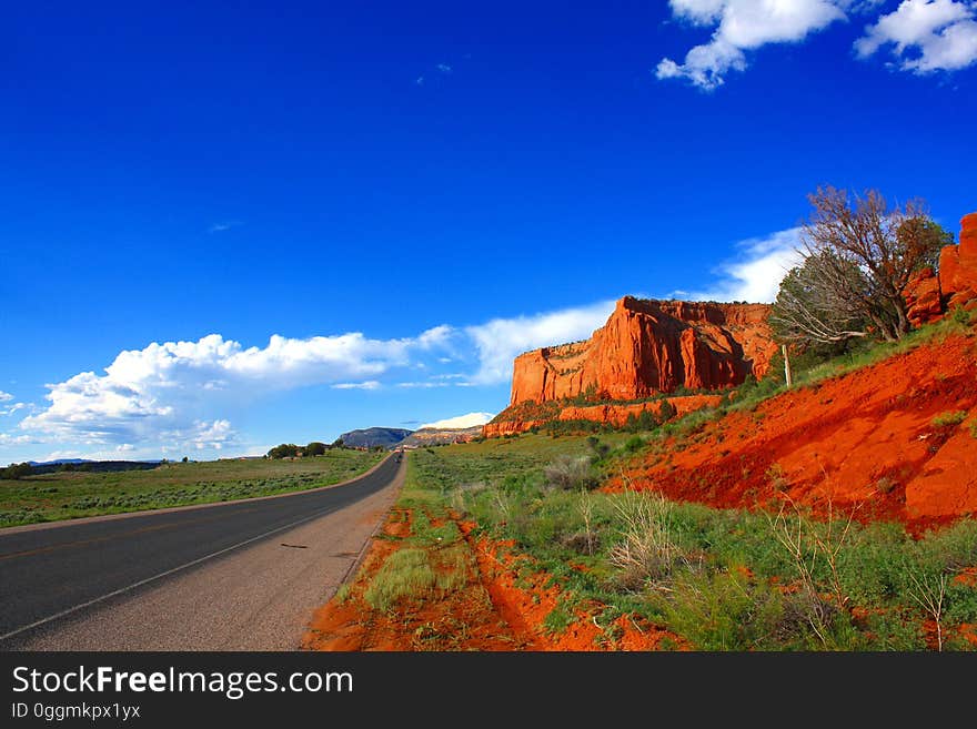 A road passing by red rocks in Arizona.