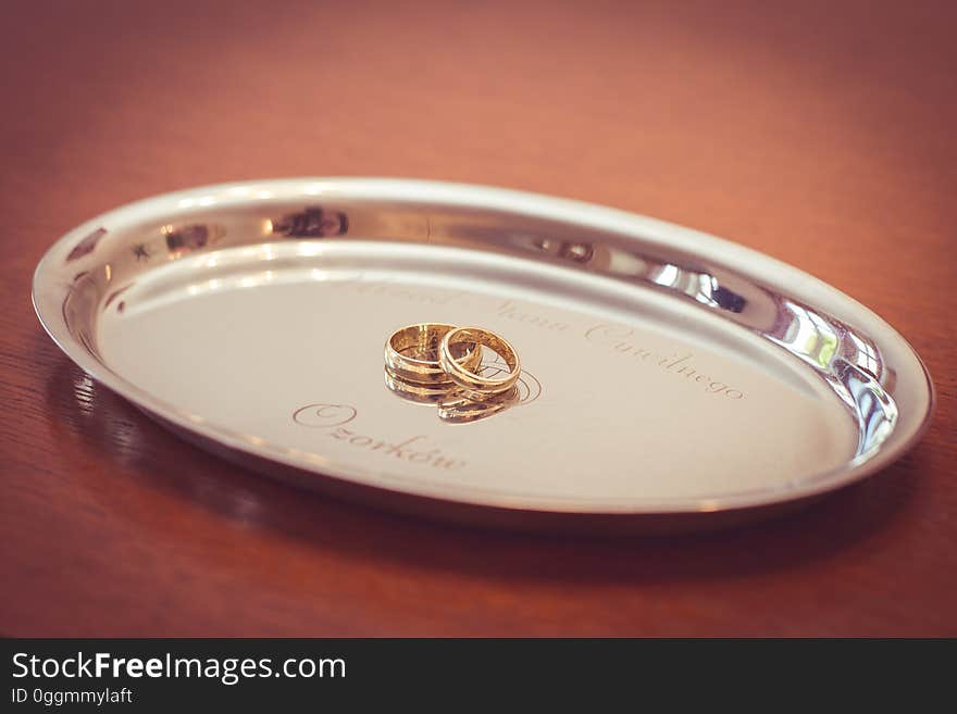 A pair of wedding rings on a silver plate. A pair of wedding rings on a silver plate.