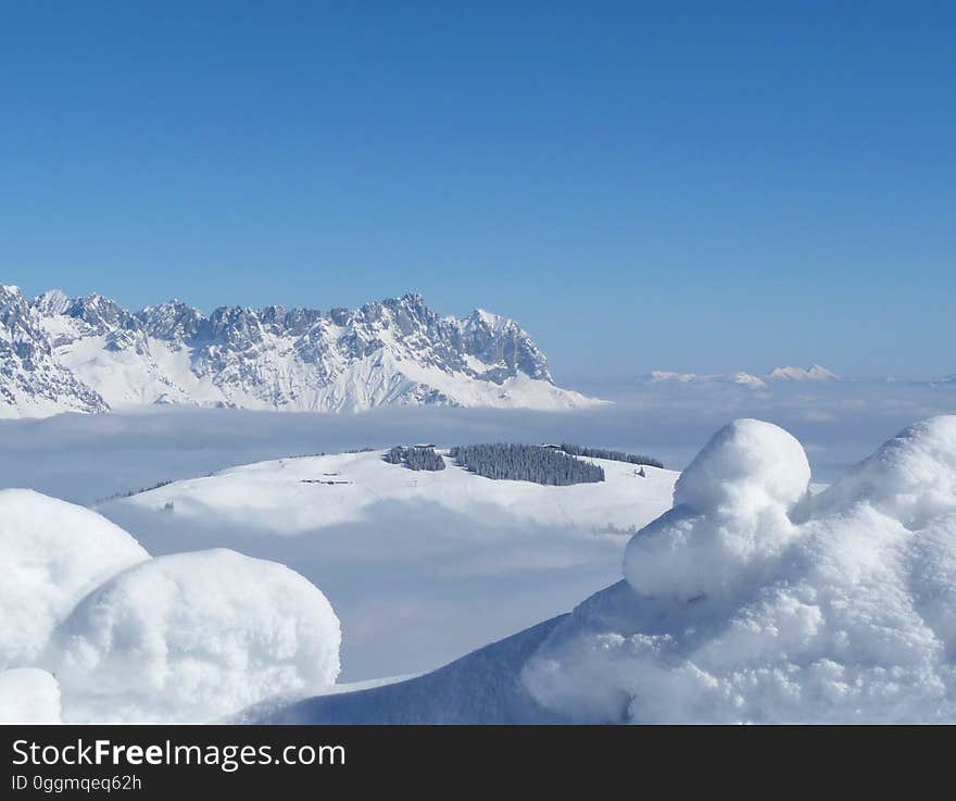 Scenic View of Snow Mountains Against Blue Sky