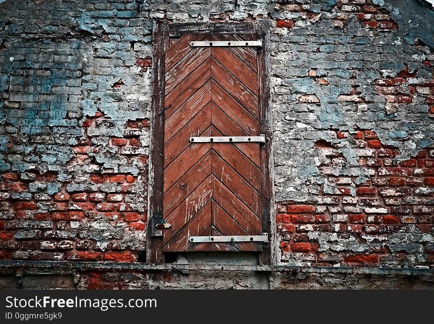 An old door in a weathered brick wall. An old door in a weathered brick wall.