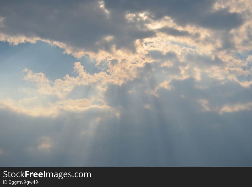 Sky with sun rays coming down through the clouds. Sky with sun rays coming down through the clouds.