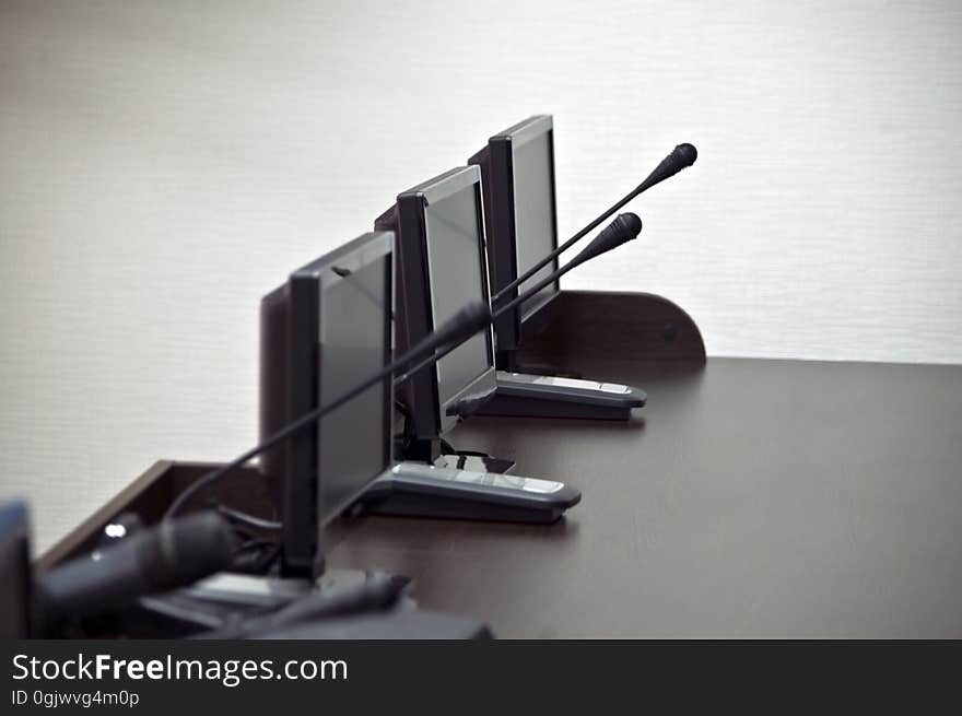 Wooden Table With Monitors And Microphones In Press-center