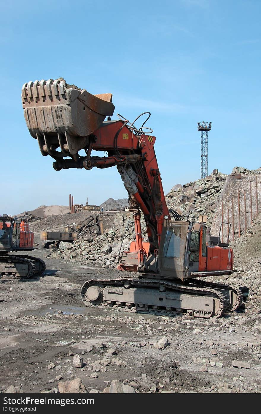 Bulldozer with bucket loads stones