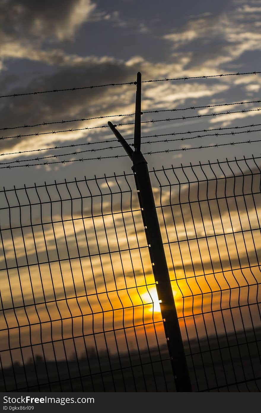 Gray Metal Fence during Sunset