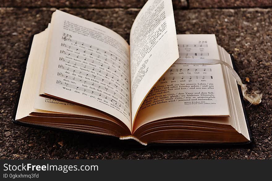 A close up of an open music notes book.