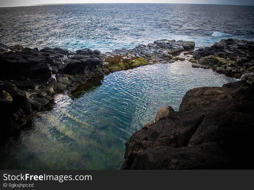 Closeup view of a rocky shoreline with the open ocean beyond. Closeup view of a rocky shoreline with the open ocean beyond.