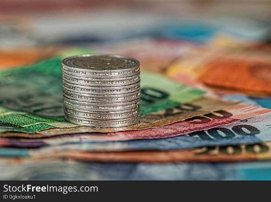 A stack of coins on paper money.