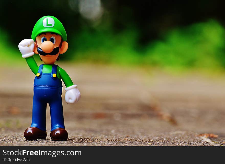 Shallow Focus Photography of Luigi Plastic Figure