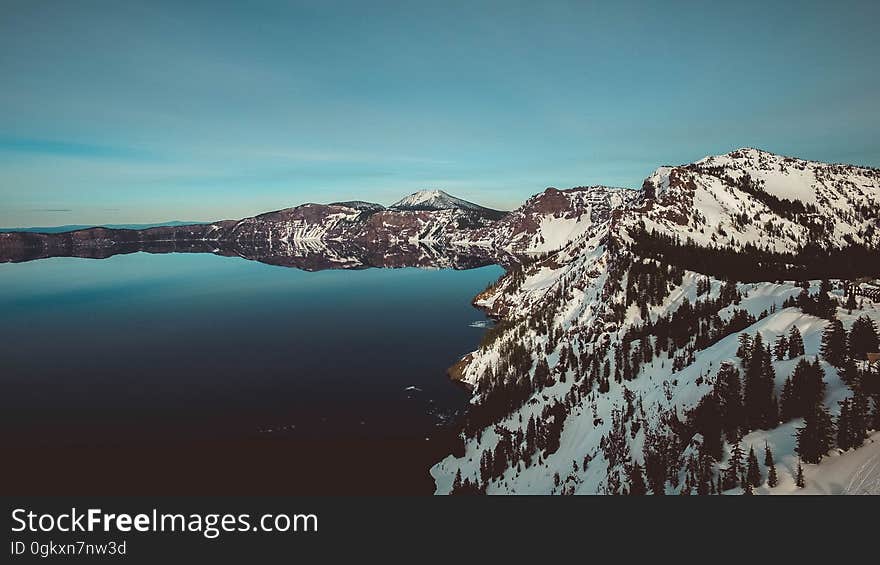 A lake in the mountains covered in snow. A lake in the mountains covered in snow.