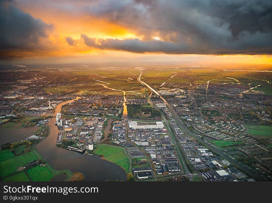 A city on the river delta with green fields at sunset. A city on the river delta with green fields at sunset.