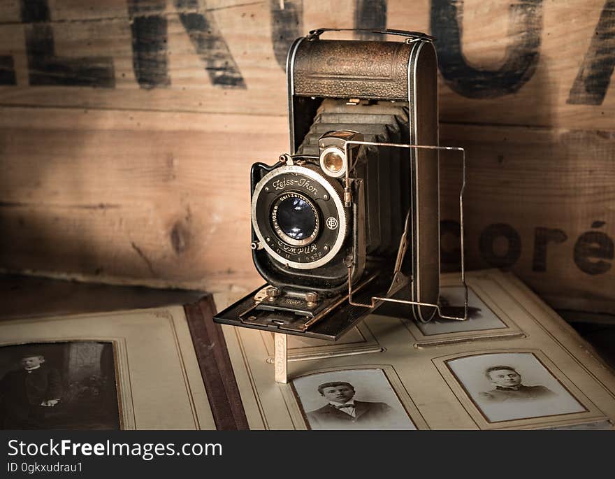 A retro film camera on top of an old album.