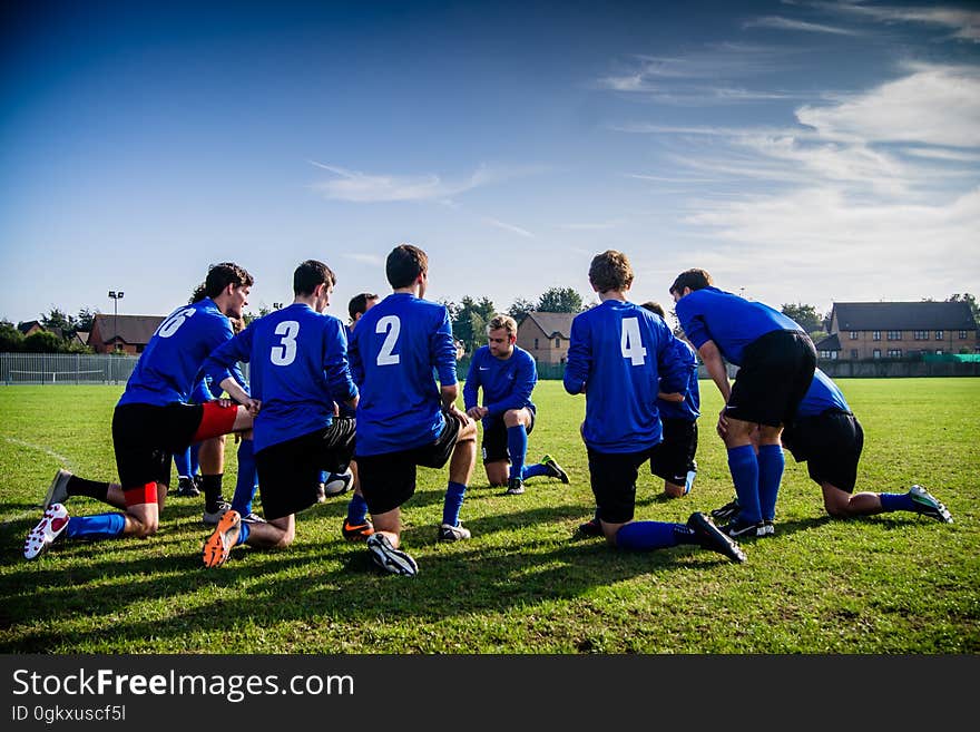 A soccer team planning their moves before the game or during a time out. A soccer team planning their moves before the game or during a time out.