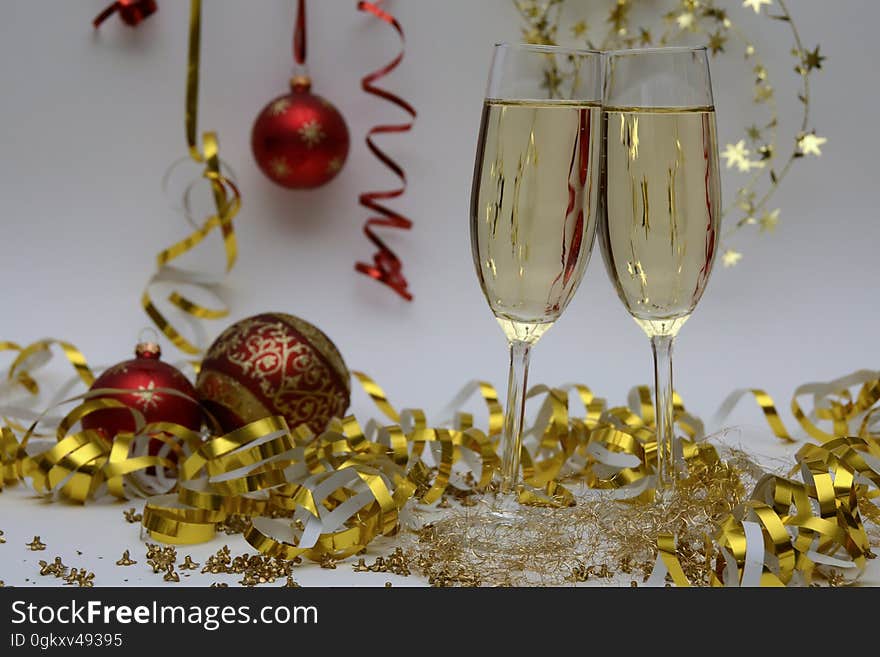 A pair of glasses of sparkling wine with Christmas and holiday decorations. A pair of glasses of sparkling wine with Christmas and holiday decorations.