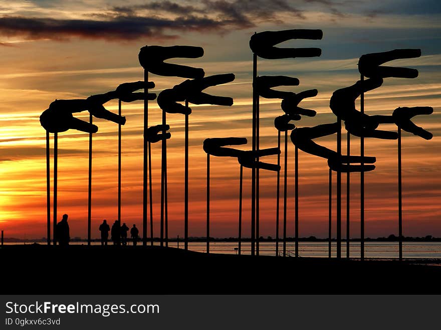 Silhouette Parasols Against Dramatic Sky during Sunset