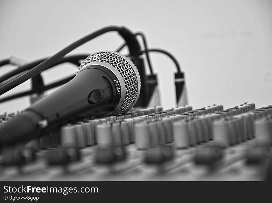 Closeup of a microphone on a soundboard.