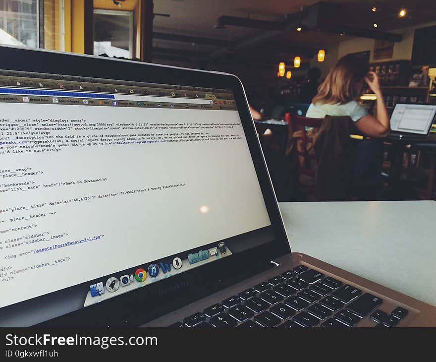 A laptop open on a coffee shop table. A laptop open on a coffee shop table.