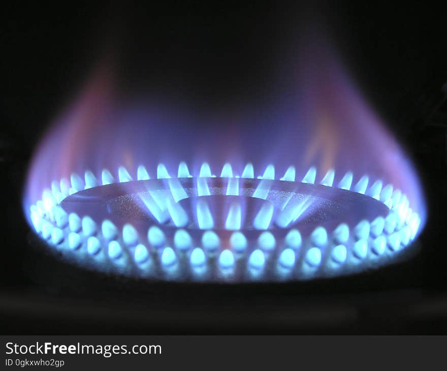 A burning gas burner with blue flame.