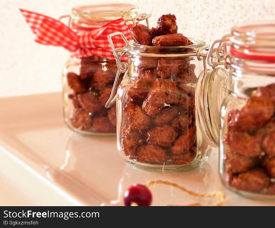 Home baked sweet nuts in transparent jars. Home baked sweet nuts in transparent jars.