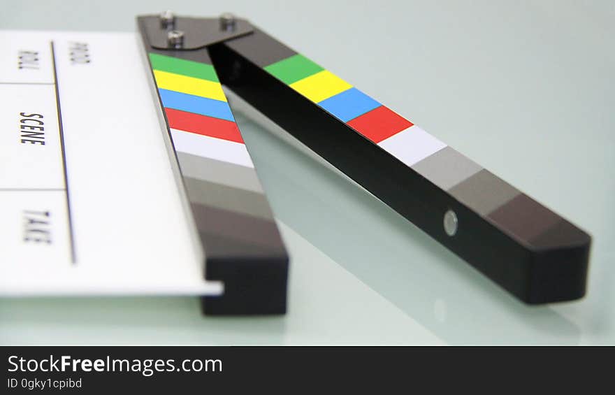 A clapperboard on a reflecting background. A clapperboard on a reflecting background.