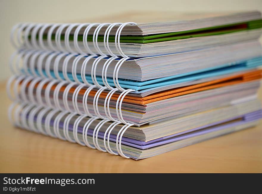 A stack of books with spring or coil binders. A stack of books with spring or coil binders.