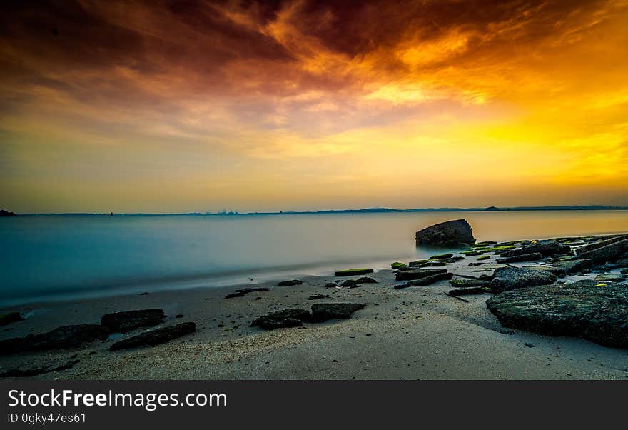 A beautiful beach sunset over tranquil waters. A beautiful beach sunset over tranquil waters.