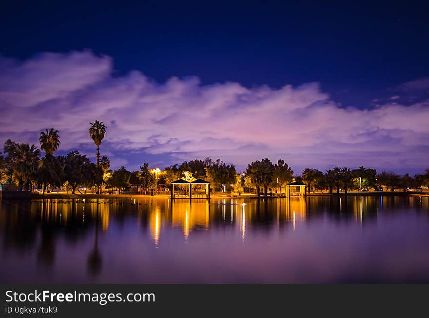 Lights on the shore of a lake at dusk. Lights on the shore of a lake at dusk.