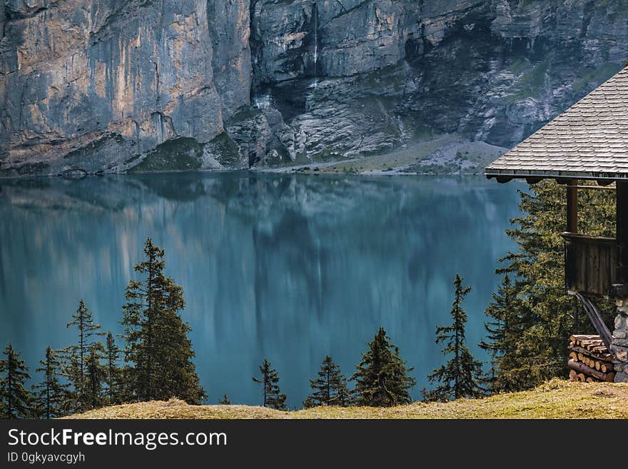 A cabin on the shore of a mountain lake. A cabin on the shore of a mountain lake.