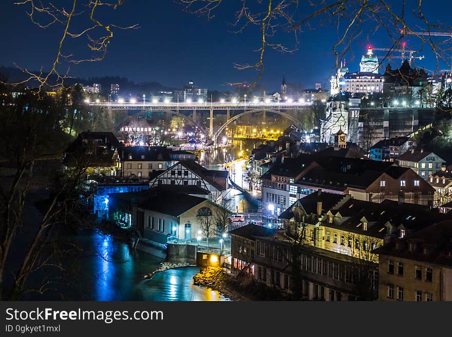 A view of a city with colorful lights at night. A view of a city with colorful lights at night.